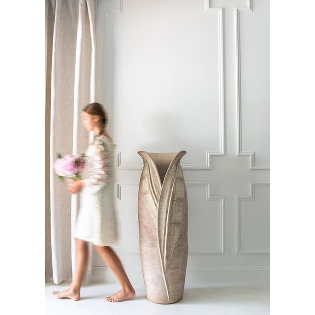 Crafted from natural terracotta with a textured finish, this floor vase is a striking piece of art. Perfect for entryways,...