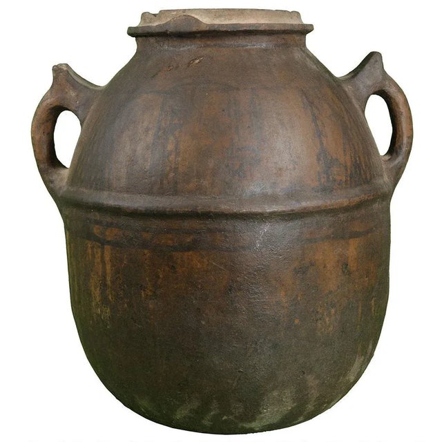 Handcrafted Moroccan vessel with ornate Berber tattoo design and intricate handles, used by Berber tribes to store water....