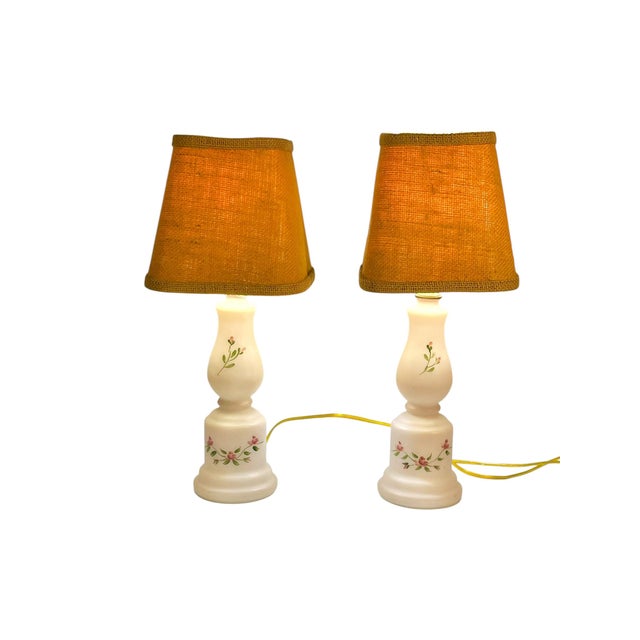 Charming and versatile, this pair of vintage glass table lamps features delicate hand-painted floral motifs on softly...