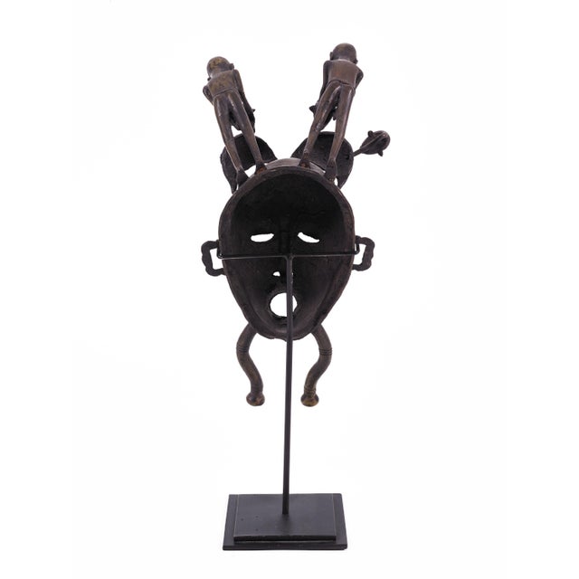 Ivory Coast Senufo Kpelie Cast Bronze Baul Mask Depicting Tribesmen on Stand For Sale - Image 4 of 4