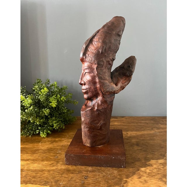 Exceptional vintage hand-carved burl wood sculpture depicting an elegant abstract female profile emerging naturally from...