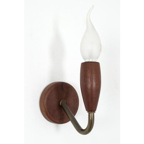 Teak wall lamps with brass. These lamps will be sold as set excl. Bulbs. In a good vintage condition. Measurements h. 12...