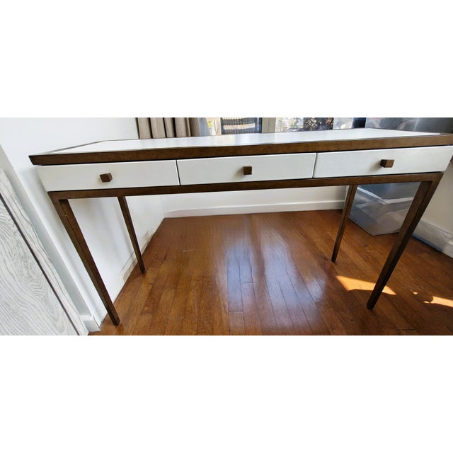 The Julian Chichester Frank Console Table is a Jean-Michel Frank-inspired design piece featuring a slim silhouette, gilded...