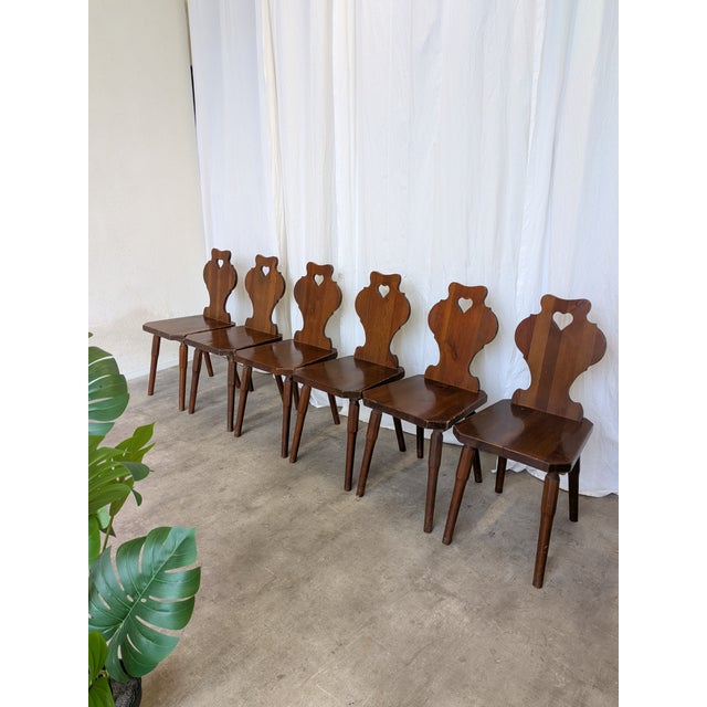Vintage wooden dining chairs in traditional Tyrolean (Alpine) style. with a shaped backrest and characteristic heart cut-...
