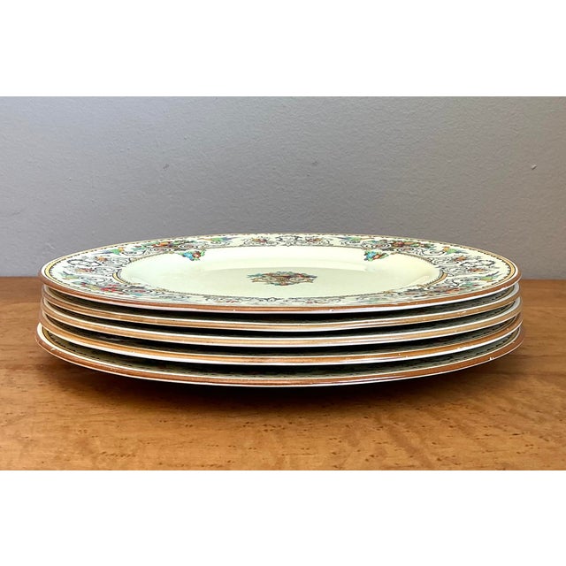 Elevate your dining experience with this exquisite set of five dinner plates from the renowned Crown Staffordshire of...
