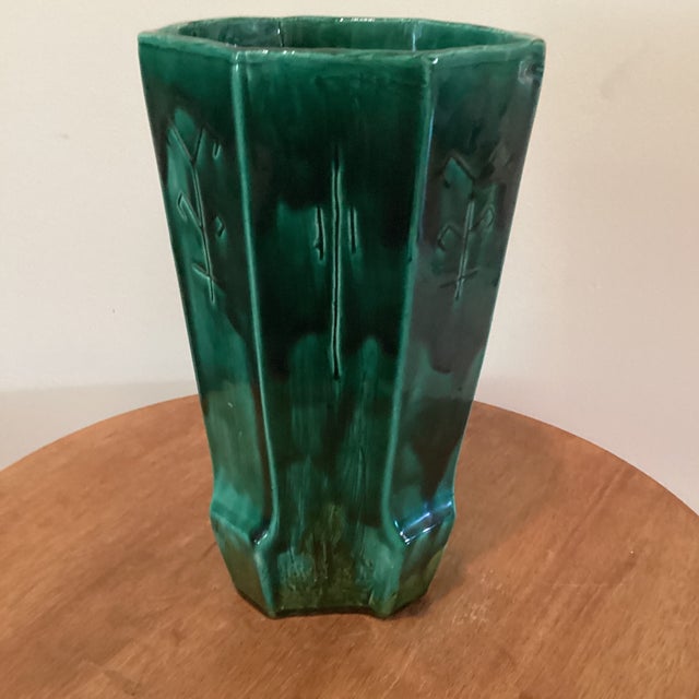 This rare emerald green ceramic vase features an etched design and geometric runes symbols, adding a unique and artistic...
