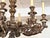 A striking 8-arm antique Italian chandelier crafted from richly carved wood and finished in a warm, timeworn patina with...