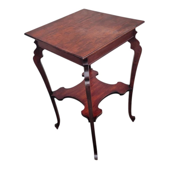 Antique 19th century Edwardian occasional table crafted from solid cherry wood. This elegant piece features a two-tier...