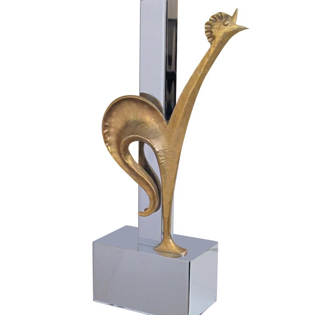 the chrome body with square support and base supporting an upright hand-hammered gilt-bronze crowing rooster