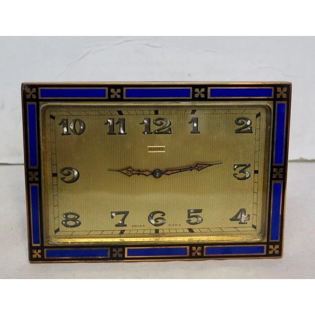 This vintage early 1930's Art Deco desk clock is designed in bronze with an enamel border. The large rectangular gold tone...