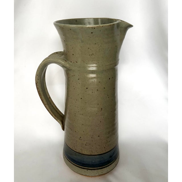 A striking, generously proportioned vintage studio pottery pitcher distinguished by its elegant architectural silhouette,...