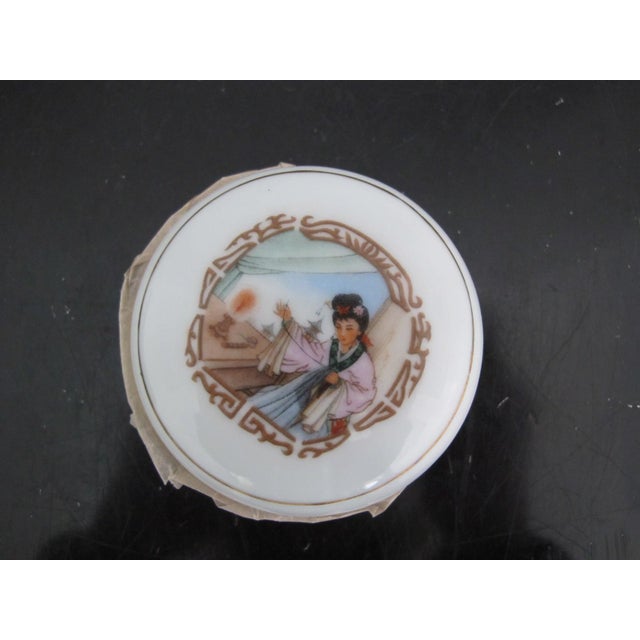 Vintage Chinese porcelain seal ink container or cinnabar ink pad. Showing design of woman sewing. Vintage, most likely...