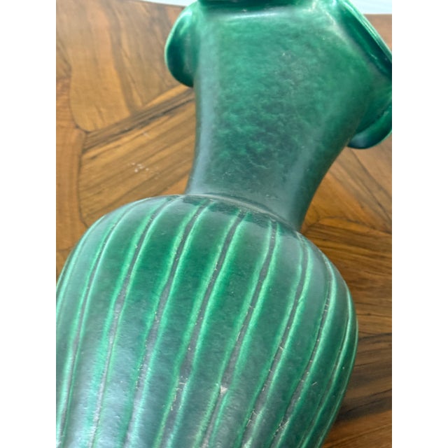 Design Plus Gallery presents a Green Ribbed Pottery Vase, an Antique Replica. The piece has a deep green glossy glazed...