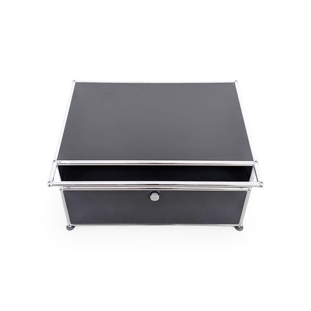 We are offering a beautiful USM Haller coffee/side table in black for sale. The piece features a large drawer, an open...
