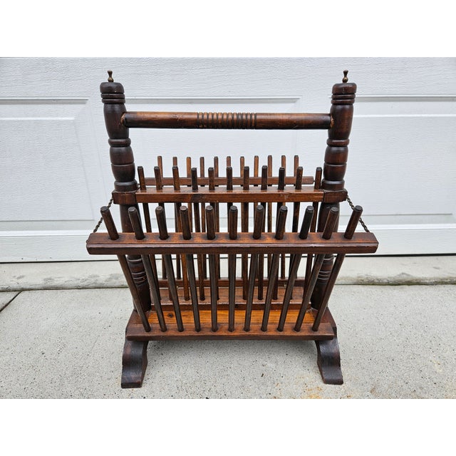 This Arts and Craft or Folk Art magazine rack features spindles and metal accents at the top of each spindle as well as at...