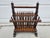 This Arts and Craft or Folk Art magazine rack features spindles and metal accents at the top of each spindle as well as at...