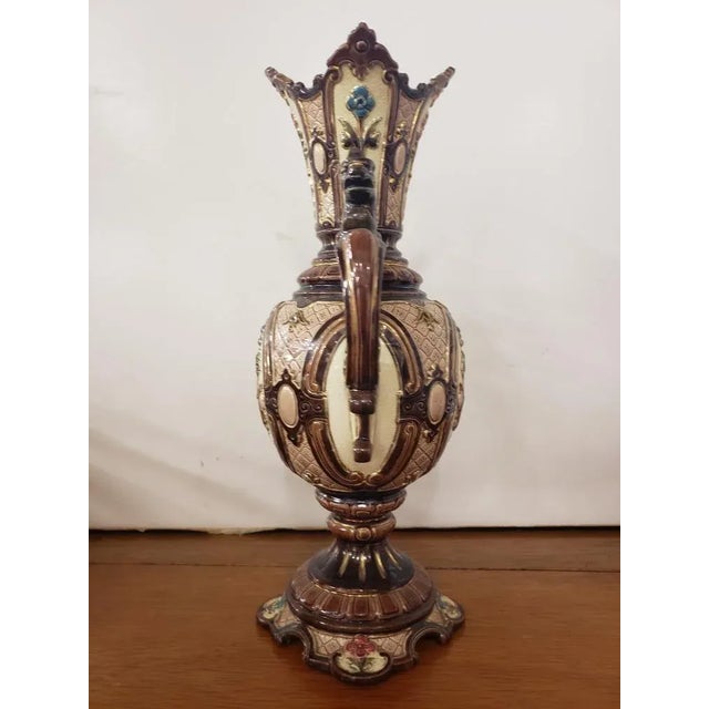 This Circa 1900 Bohemian Renaissance Revival Majolica Gryphon Handled Footed Vase. It measures 14 1/8" high, 8 1/4" wide...