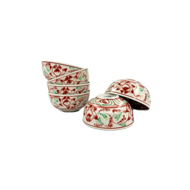 A beautiful set of six handcrafted ceramic bowls from Bat Trang, Vietnam, featuring an intricate hand-painted lotus floral...