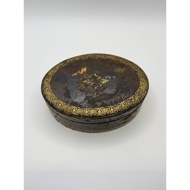 A beautifully aged Italian Florentine leather box, featuring classic gold tooled detailing and a warm, rich patina. The...