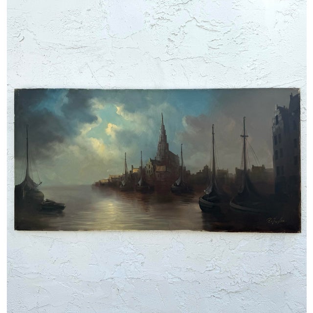 This atmospheric landscape painting captures a quiet, golden moment along a bay, where the light seems to pool in the...