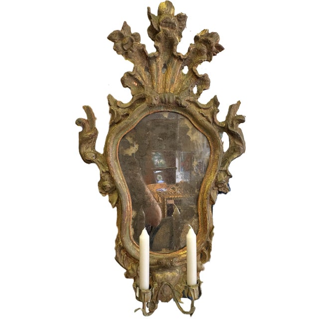 Rare survivor! This is an amazing wood wall mirror from the 17th century. It is hand carved of wood with two metal flower...