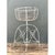 This vintage wire plant stand rises in a graceful hourglass silhouette, pairing a deep, bowl-shaped basket with a domed...