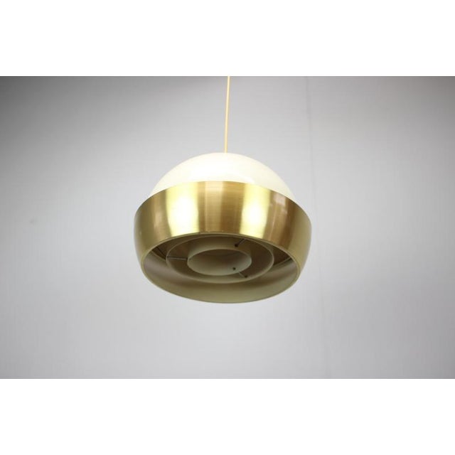 Elegant Mid-Century Modern pendant lamp produced in Europe during the 1970s, attributed to Czechoslovak manufacture. This...