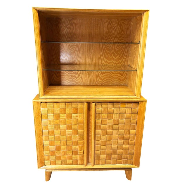 Restored Mid-century bleached oak "Basket Weave" china cabinet designed by Paul Laszlo for Brown Saltman. This classic...