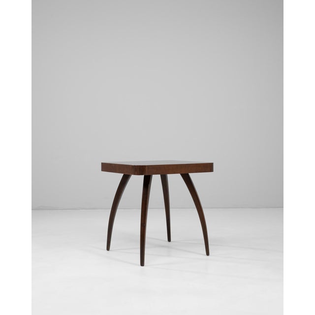 This 1960s Czech walnut spider table by renowned designer Jind?ich Halabala exemplifies his innovative approach to...