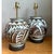 This pair of vintage ceramic lamps presents a full, globular silhouette with a short, flared neck and a softly rounded...