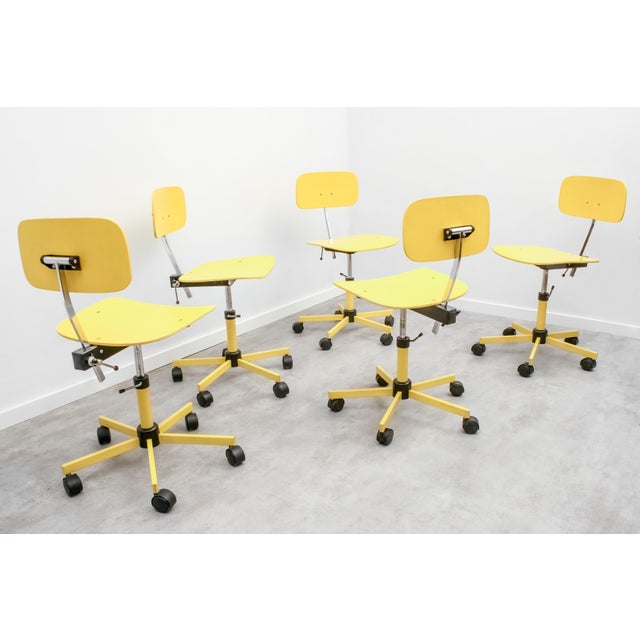 These Kevi chairs, with their original bright yellow paint, were designed by Jørgen Rasmussen and produced by Rabami in...