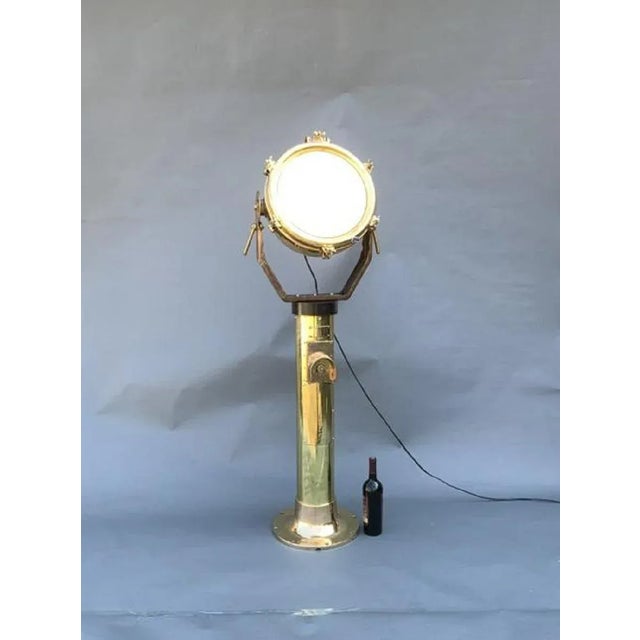 Nautical spotlight. Great piece of industrial lighting. Solid brass and highly polished, fitted to a heavy brass pedestal....