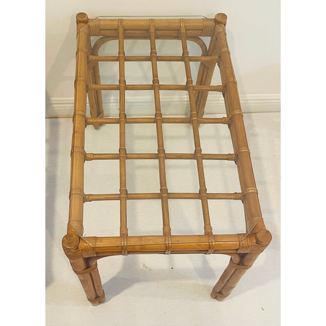 Elegant pair of mid century modern bamboo side tables with original glass tops.