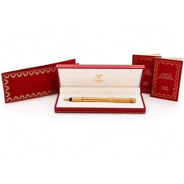 Vintage must de cartier trinity fountain pen, made in france circa the 1980s, with patterned 18ct gold-plated barrel and...