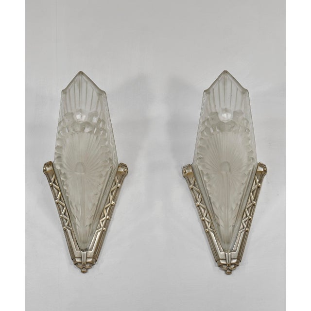 Charles Schneider A wonderful pair of French art deco wall sconces made around 1930. The solid brass mounts hold beautiful...