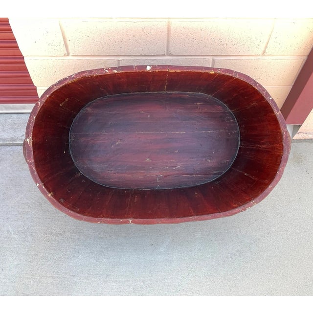 A large Asian, iron-banded, red lacquered sectioned wood tub, early 20th century. Striking when filled with greenery and...