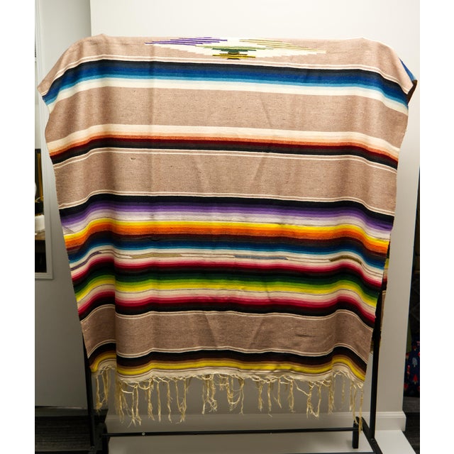 A genuine mid twentieth century hand loomed wool Puebla Saltillo sarape (zarape) blanket. Brightly colored polychrome...