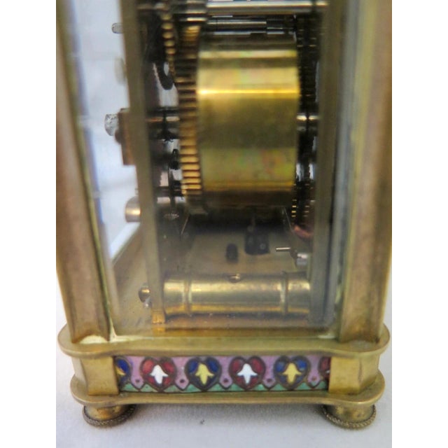 This vintage French late 19th century carriage clock is beautifully accented with a colorful champleve border design. The...