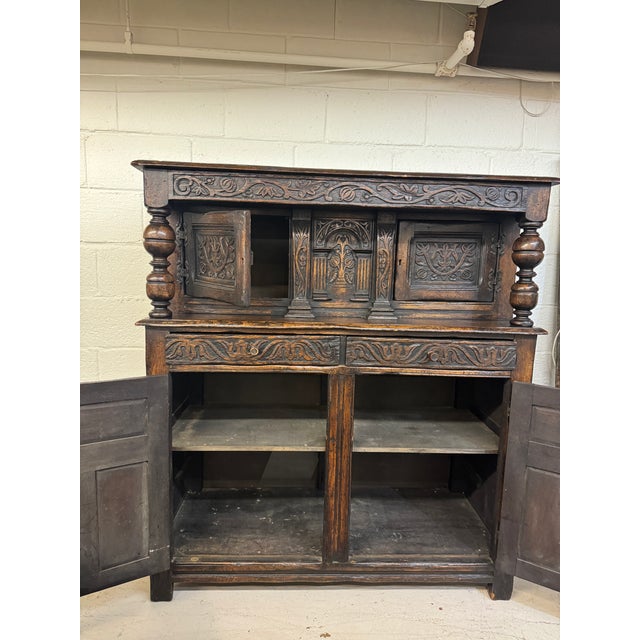 Jacobean Court Cupboard with carved wood and Balusters. Wood is solid. Back has been replaced. Only minor scratch surface...