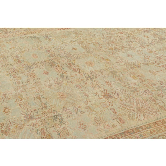 Handwoven in wool, this oversized antique 12x21 Persian Mahal Farahan rug dates to circa 1920–1930. The rug features a...