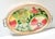 A charming 1960s oval gallery tray featuring a vibrant designer floral fabric insert framed in warm brass with classic...
