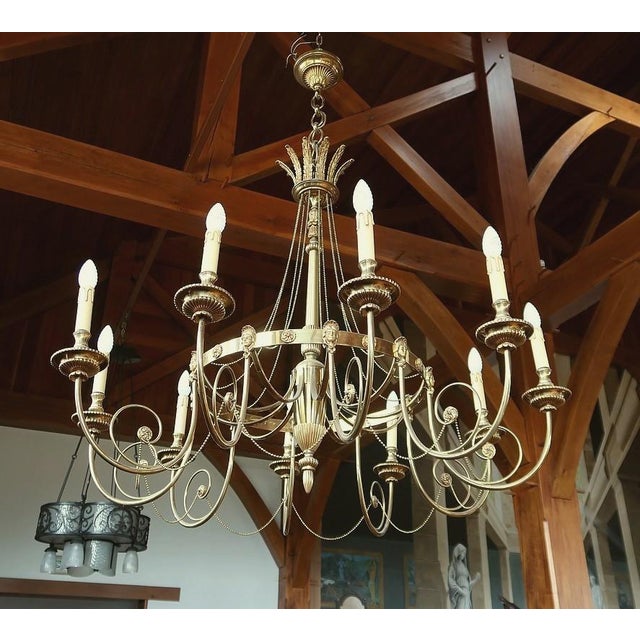 Magnificent set of three large identical chandeliers, in bronze and brass, for prestigious residence. Elegant and of rare...