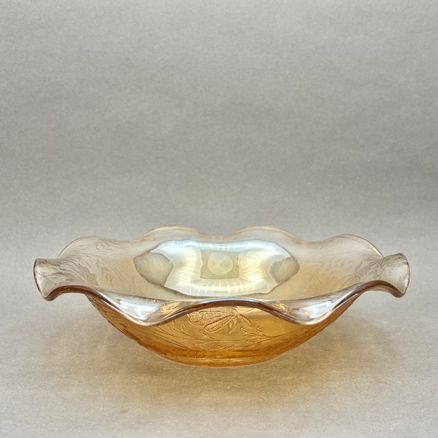 Vintage Jeannette Glass Co. iridescent marigold glass bowl, featuring a highly detailed impressed floral motif and an...
