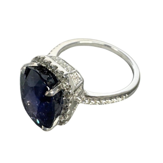 Centering an 8.53 carat natural blue sapphire, this elegant cocktail ring features an oval brilliant-cut gemstone...