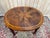 Oval dining table, late 19th century, louis xvi style, with a book-matched walnut marquetry top featuring a star motif....