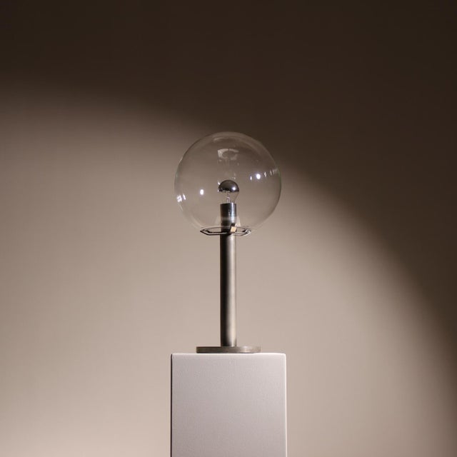 This table lamp is a puristic design object featuring a remarkable lighting effect, sourced from an architect’s estate and...