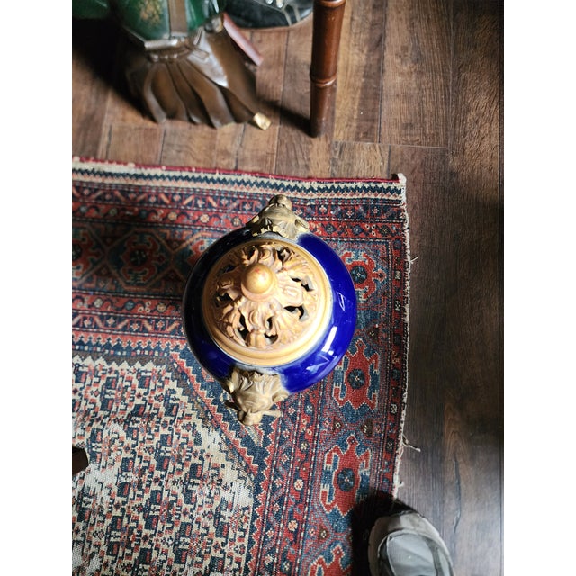 Beautiful Blue Sevres urn vase that has been modified with a custom wood carved lid with a gold finish and stunning ormolu...