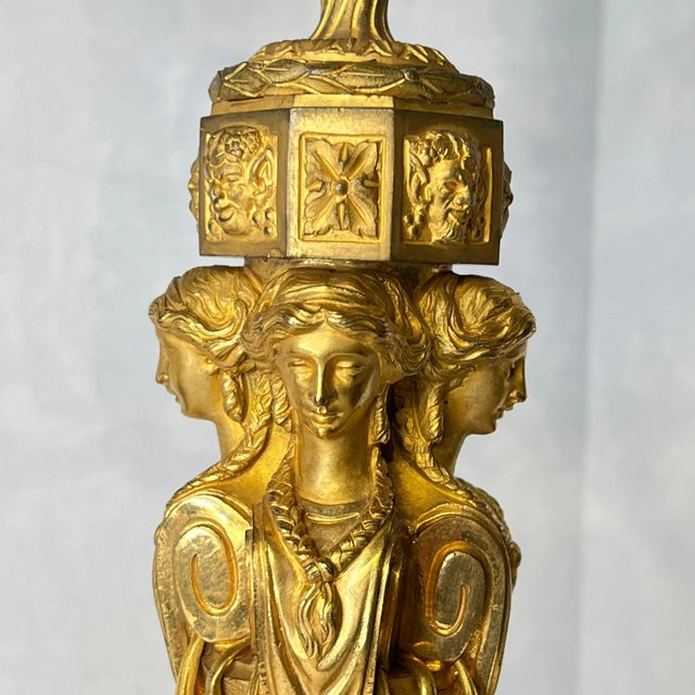 Pair of large gilt bronze candelabra from the Egyptian Revival period, with seven lights and finely cast figurative designs.
