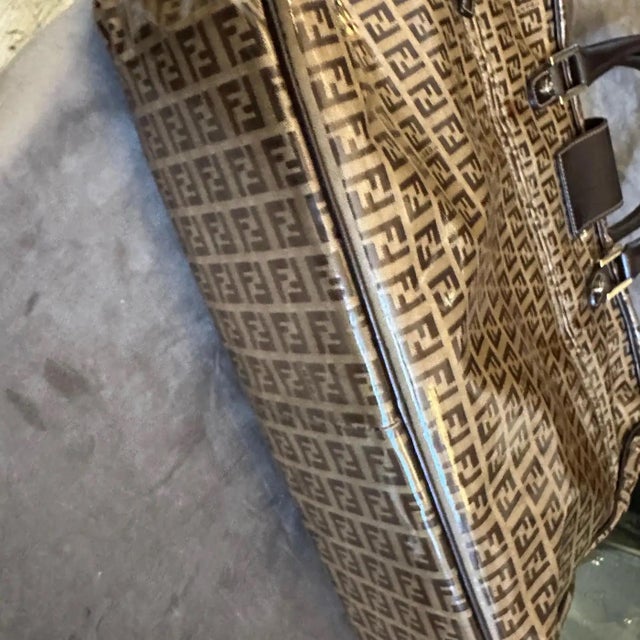 This remarkable Fendi top-handle bag is a classic piece of 1980s Italian luxury, instantly recognizable by its signature...