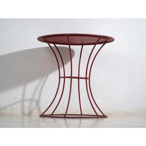 This antique table in painted metal is a European industrial piece, originally conceived as a functional auxiliary or...